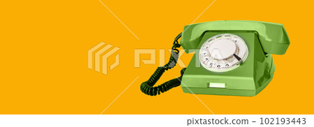 Retro rotary green phone with cord on orange ad banner background with copy space for text Retro rotary green phone with cord on orange ad banner background with copy space for text 102193443
