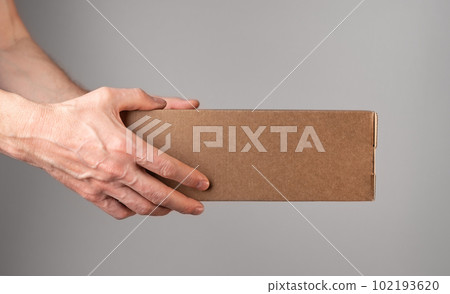 Hand holding cardboard box, parcel, order package, closed pack Hand holding cardboard box, parcel, order package, closed pack 102193620