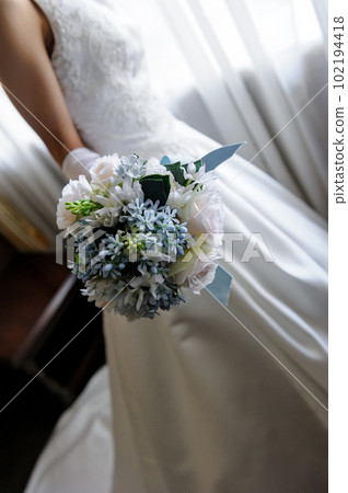 A bride with a bouquet in hand A bride with a bouquet in hand 102194418