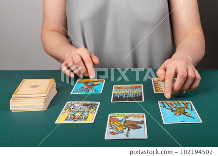 Lodz Poland April 25 2023 Tarot reader, fortune teller spreading esoteric playing cards for divination Lodz Poland April 25 2023 Tarot reader, fortune teller spreading esoteric playing cards for divination 102194502