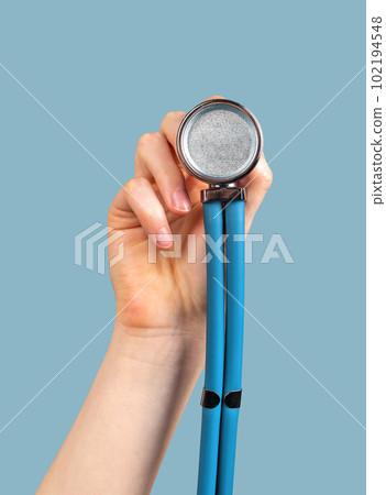 Hand holding stethoscope on blue background, to you me Hand holding stethoscope on blue background, to you me 102194548