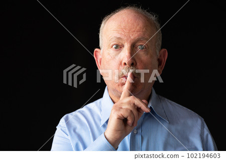 Grey haired senior man with finger on lips for silence or secret Grey haired senior man with finger on lips for silence or secret 102194603