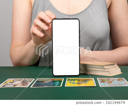 Tarot card reading with mobile phone screen mockup. Taro reader with modern application on smartphone 102194679