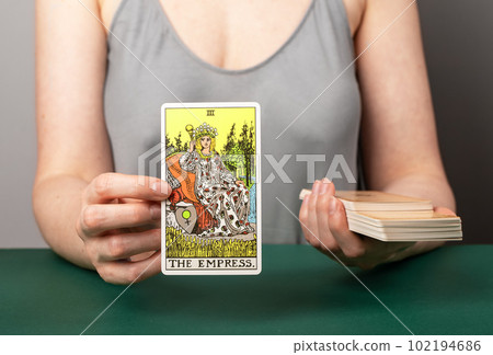 Lodz Poland April 15 2023 Empress arcana, tarot readers hand holding showing taro card during divination Lodz Poland April 15 2023 Empress arcana, tarot readers hand holding showing taro card during divination 102194686