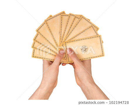 Lodz Poland April 15 2023 Tarot cards in hands for choosing, picking isolated on white Lodz Poland April 15 2023 Tarot cards in hands for choosing, picking isolated on white 102194728