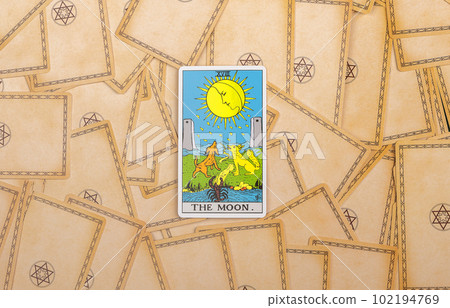 Lodz Poland April 15 2023 Moon, major arcana on tarot cards deck background. Taro divination concept Lodz Poland April 15 2023 Moon, major arcana on tarot cards deck background. Taro divination concept 102194769
