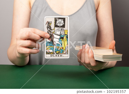 Lodz, Poland April 07 2023 Death tarot card, major arcana with skeleton, horse rider in hand of fortune teller 102195357