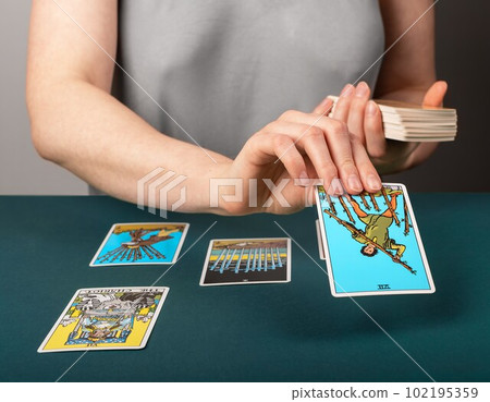 Lodz, Poland April 07 2023 Tarot reader spreading taro cards on desk, reading future, fortune telling 102195359