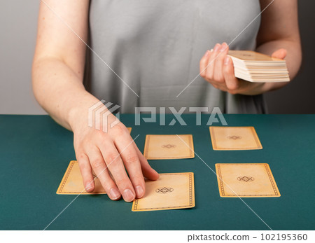 Lodz, Poland April 07 2023 Tarot reader teller spreading taro cards backside on desk, pentagram divination, reading future, fortune telling Lodz, Poland April 07 2023 Tarot reader teller spreading taro cards backside on desk, pentagram divination, reading future, fortune telling 102195360