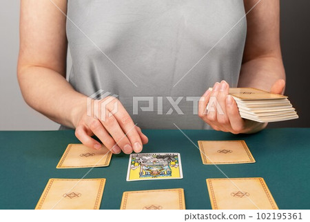 Lodz, Poland April 07 2023 Tarot reader teller spreading taro cards, pentagram divination, reading future, fortune telling 102195361