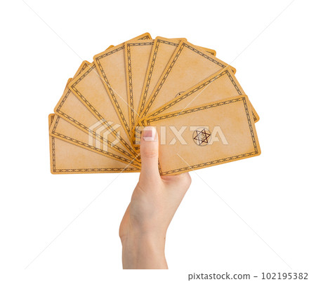 Hand holding tarot cards with back view, backside design isolated on white background Hand holding tarot cards with back view, backside design isolated on white background 102195382