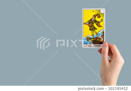 The Fool, tarot card in hand. Banner background with copy space for text The Fool, tarot card in hand. Banner background with copy space for text 102195432