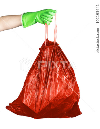 Hand holding red garbage bag with non-recyclable waste, trash sack full of hazardous substances rubbish isolated on white background 102195441