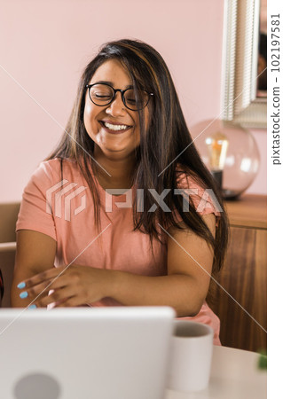Happy indian woman freelancer or entrepreneur have video conference talking, working remotely online at home office - video call and diversity concept 102197581