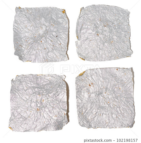 Fragments of gray foil on a white isolated background, top view Fragments of gray foil on a white isolated background, top view 102198157