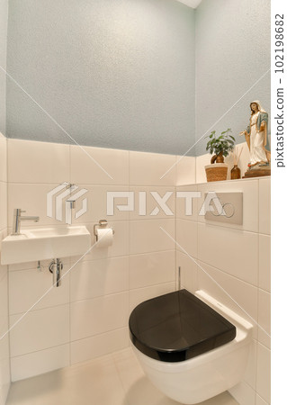 a bathroom with a toilet, sink and plant on the shelf over the toilet bowl in the wall is white a bathroom with a toilet, sink and plant on the shelf over the toilet bowl in the wall is white 102198682