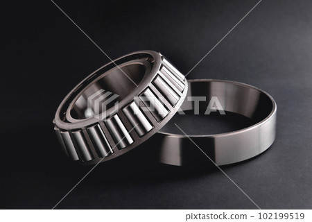 roller bearing on a black background close-up, blur as an artistic device 102199519
