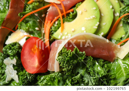 Delicious kale salad with prosciutto as background, closeup 102199765