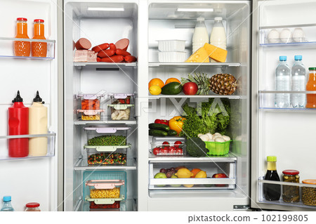 Open refrigerator full of different fresh products 102199805