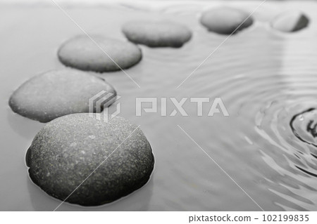 Beautiful spa stones in water, space for text. Zen lifestyle Beautiful spa stones in water, space for text. Zen lifestyle 102199835