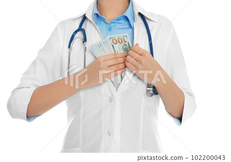 Doctor putting bribe into pocket on white background, closeup. Corruption in medicine Doctor putting bribe into pocket on white background, closeup. Corruption in medicine 102200043