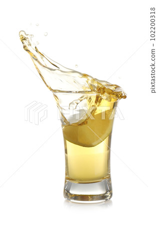 Splashing Mexican Tequila in shot glass with lime slice isolated on white Splashing Mexican Tequila in shot glass with lime slice isolated on white 102200318