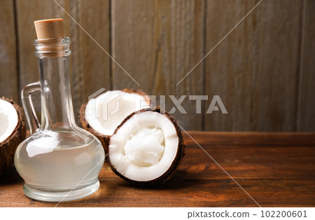 Coconut oil on wooden table. Space for text Coconut oil on wooden table. Space for text 102200601