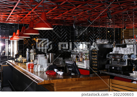Stylish interior of cafe with wooden counter 102200603