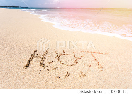 The word HOT written in the sand on beach The word HOT written in the sand on beach 102201123