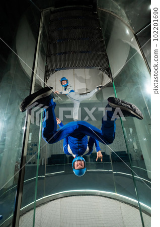 A man and a woman enjoy flying together in a wind tunnel. Free fall simulator A man and a woman enjoy flying together in a wind tunnel. Free fall simulator 102201690