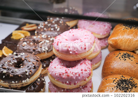 chocolate donuts display for sale at local store chocolate donuts display for sale at local store 102202316