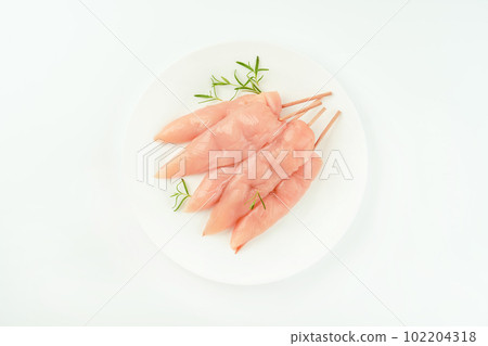 Top view.Skewers from raw chicken meat inner fillet on a white plate for a supermarket on a white background.Chicken fillet inner skewers.Food concept.Food for retail.Ogranic food,healthy eating. Top view.Skewers from raw chicken meat inner fillet on a white plate for a supermarket on a white background.Chicken fillet inner skewers.Food concept.Food for retail.Ogranic food,healthy eating. 102204318