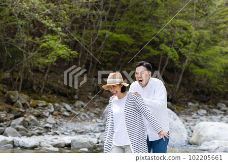 A couple enjoying playing in the river 102205661