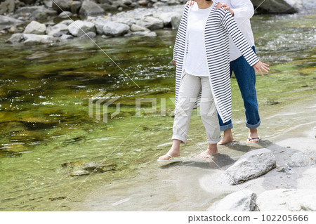A couple enjoying playing in the river 102205666