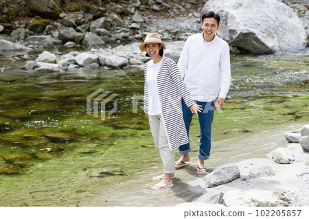A couple enjoying playing in the river 102205857