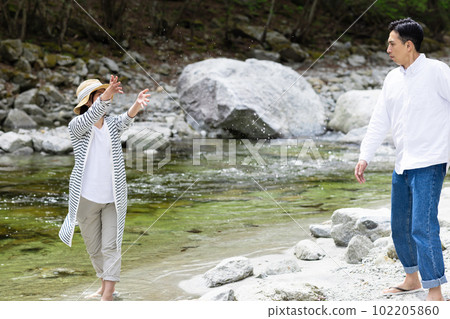 A couple enjoying playing in the river 102205860