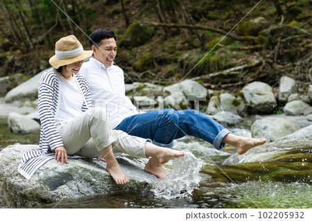 A couple enjoying playing in the river 102205932