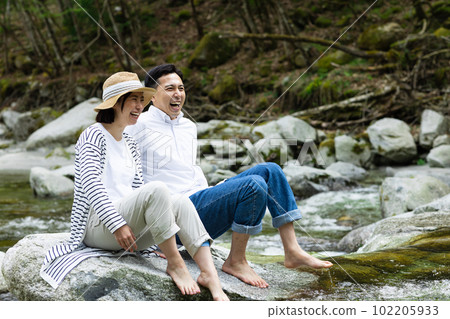 A couple enjoying playing in the river A couple enjoying playing in the river 102205933