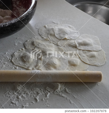 "Gyoza and roll out with a rolling pin" "Gyoza and roll out with a rolling pin" 102207878