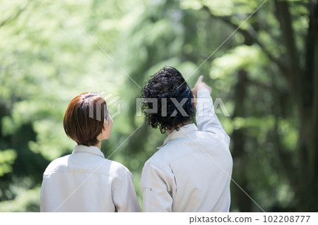 A worker pointing his finger at plants and wood in the fresh greenery A worker pointing his finger at plants and wood in the fresh greenery 102208777