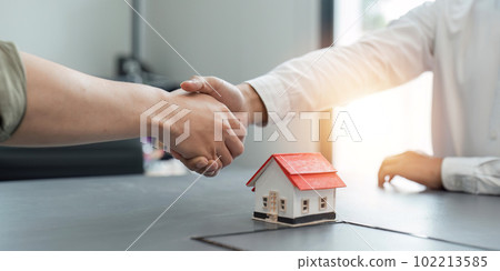 Estate agent and customer shaking hands after finished contract after about home insurance and investment loan Estate agent and customer shaking hands after finished contract after about home insurance and investment loan 102213585