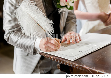 Groom's hand signing the marriage certificate Groom's hand signing the marriage certificate 102213954