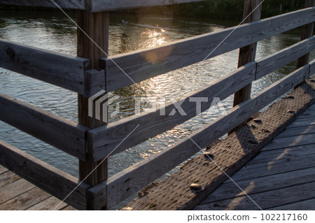 Wood bridge rail over river close up old Wood bridge rail over river close up old 102217160