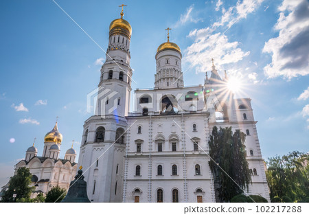 Ivan the Great Bell Tower, with Assumption Belfry on the right in Moscow Kremlin. Blue sky background with sunbeams 102217288