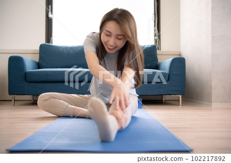 A woman who stretches and takes care of her body A woman who stretches and takes care of her body 102217892