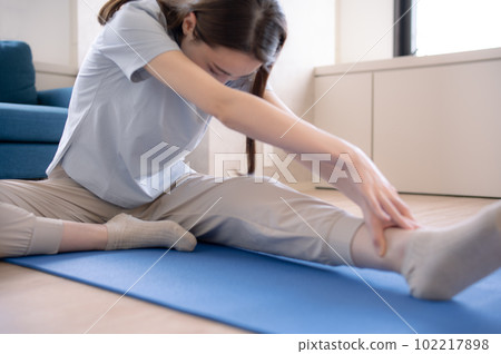 A woman who stretches and takes care of her body 102217898