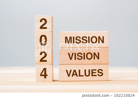 wooden block with text 2024 MISSION, VISION and VALUE on table background. Resolution, strategy, solution, goal, business and New Year holiday concepts 102218824