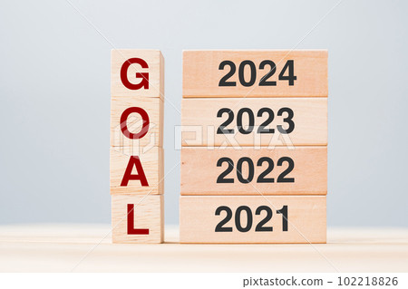 2024 block over 2023 and 2022 wooden building on table background. Business planning, Risk Management, Resolution, strategy, solution, goal, New Year New You and happy holiday concepts 102218826
