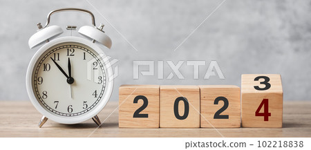 Happy New Year with vintage alarm clock and flipping 2023 change to 2024 block. Christmas, New Start, Resolution, countdown, Goals, Plan, Action and Motivation Concept 102218838