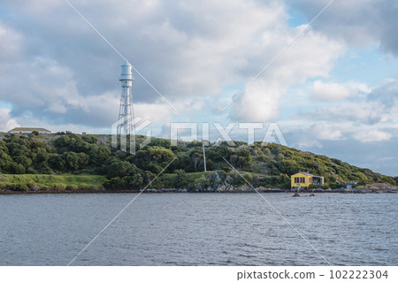 Photograph of Currie Lighthouse on a hill viewed from across the bay on King Island Photograph of Currie Lighthouse on a hill viewed from across the bay on King Island 102222304